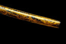 Katana Kohaku — Tamahagane, Poignée noire sur raie blanche, fourreau doré marbré, cordon noir.